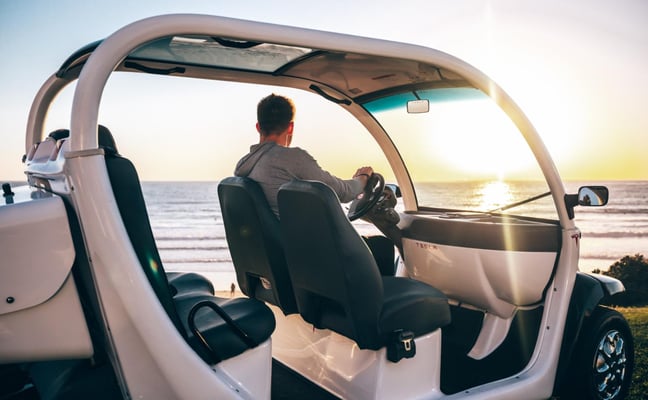 Man driving golf cart